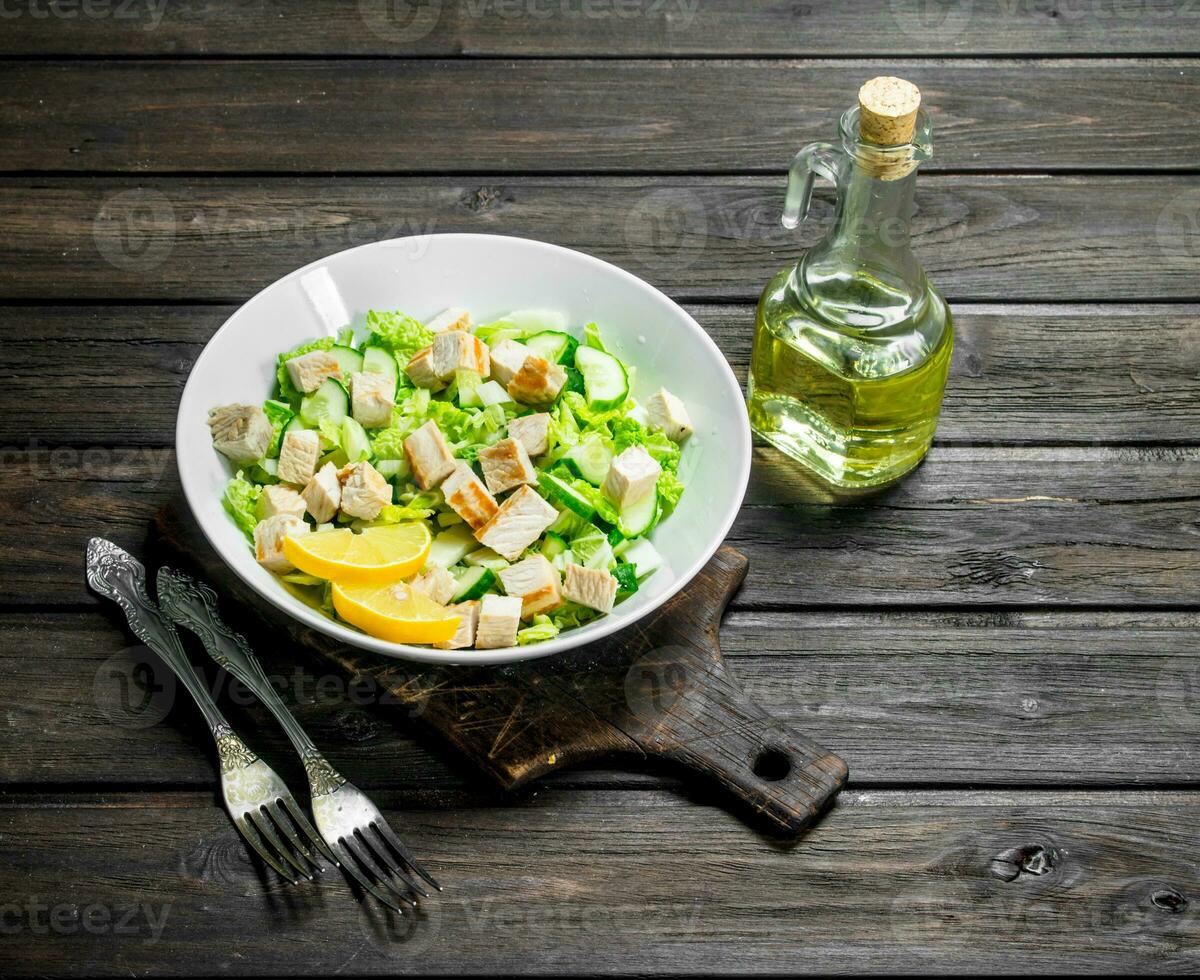 Healthy salad. Salad with cucumbers, chicken and Chinese cabbage poured lemon juice . photo