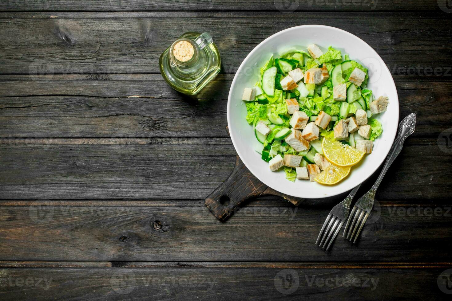 Healthy salad. Salad with cucumbers, chicken and Chinese cabbage poured lemon juice . photo