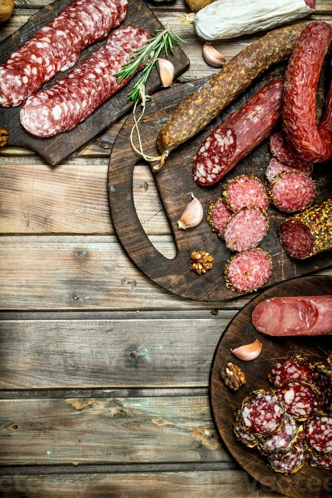 Various types of salami on a Board with nuts. photo
