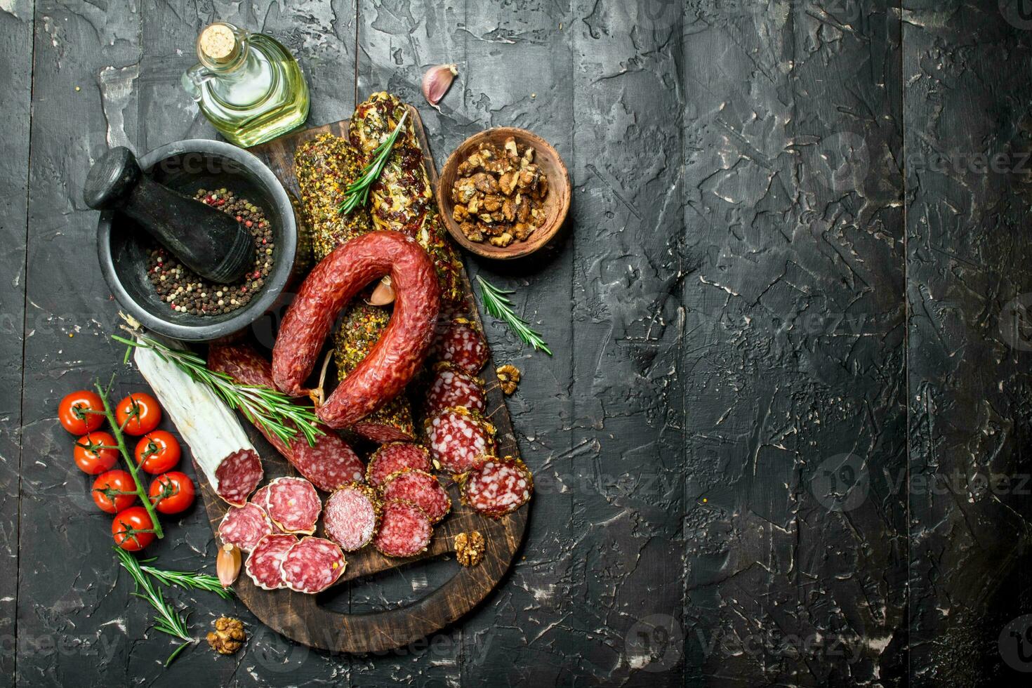 Different types of smoked salami with aromatic seasonings. photo