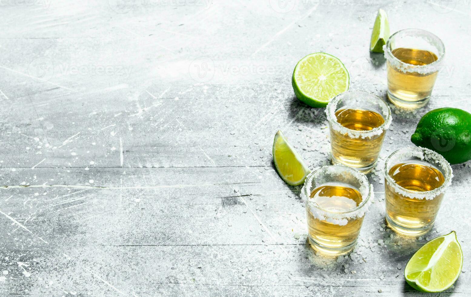 Tequila with lime wedges. photo