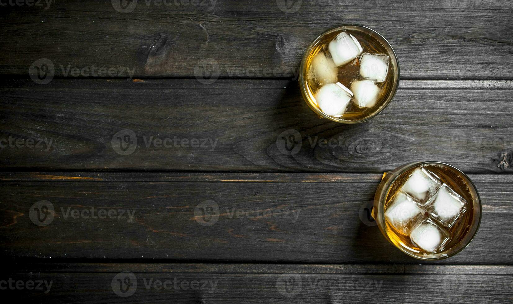 Whiskey in a glass with ice cubes. photo