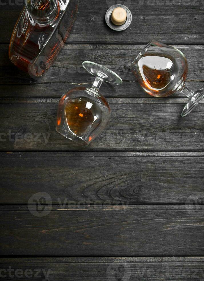 Cognac in a glass bottle and glasses. photo