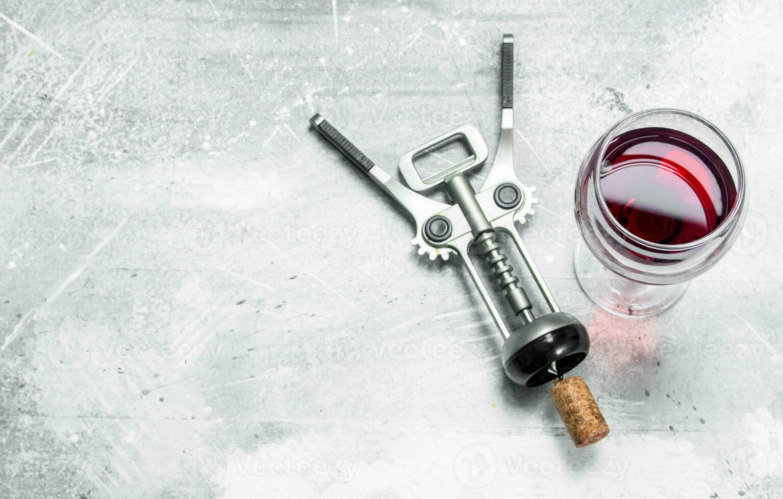 Wine background. Red wine with corkscrew. photo