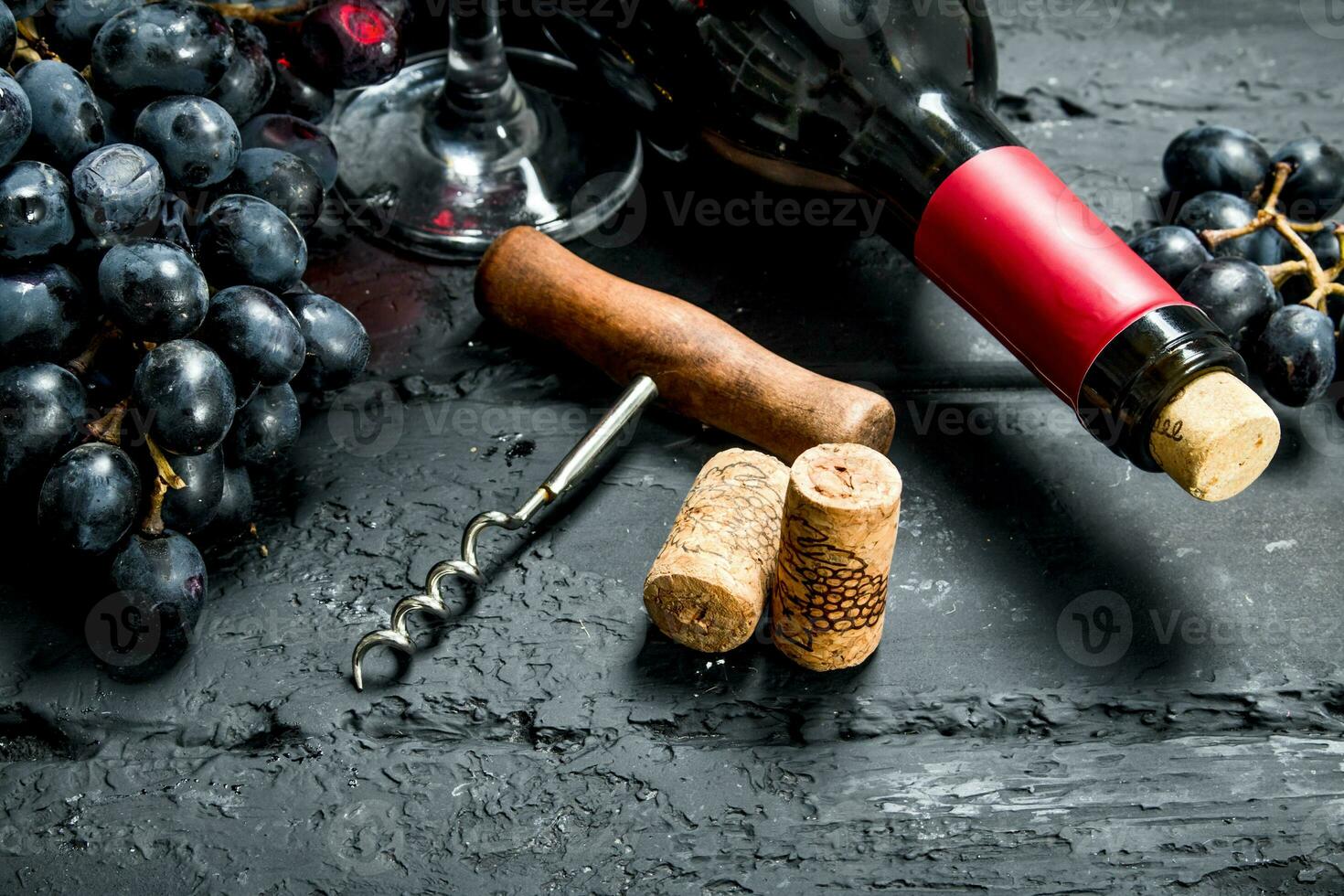 Wine background. Red wine with grapes and corkscrew. photo