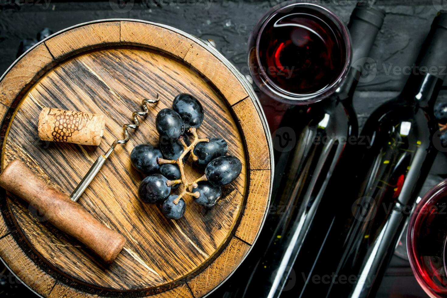 Wine background. Red wine with grapes and an old barrel. photo