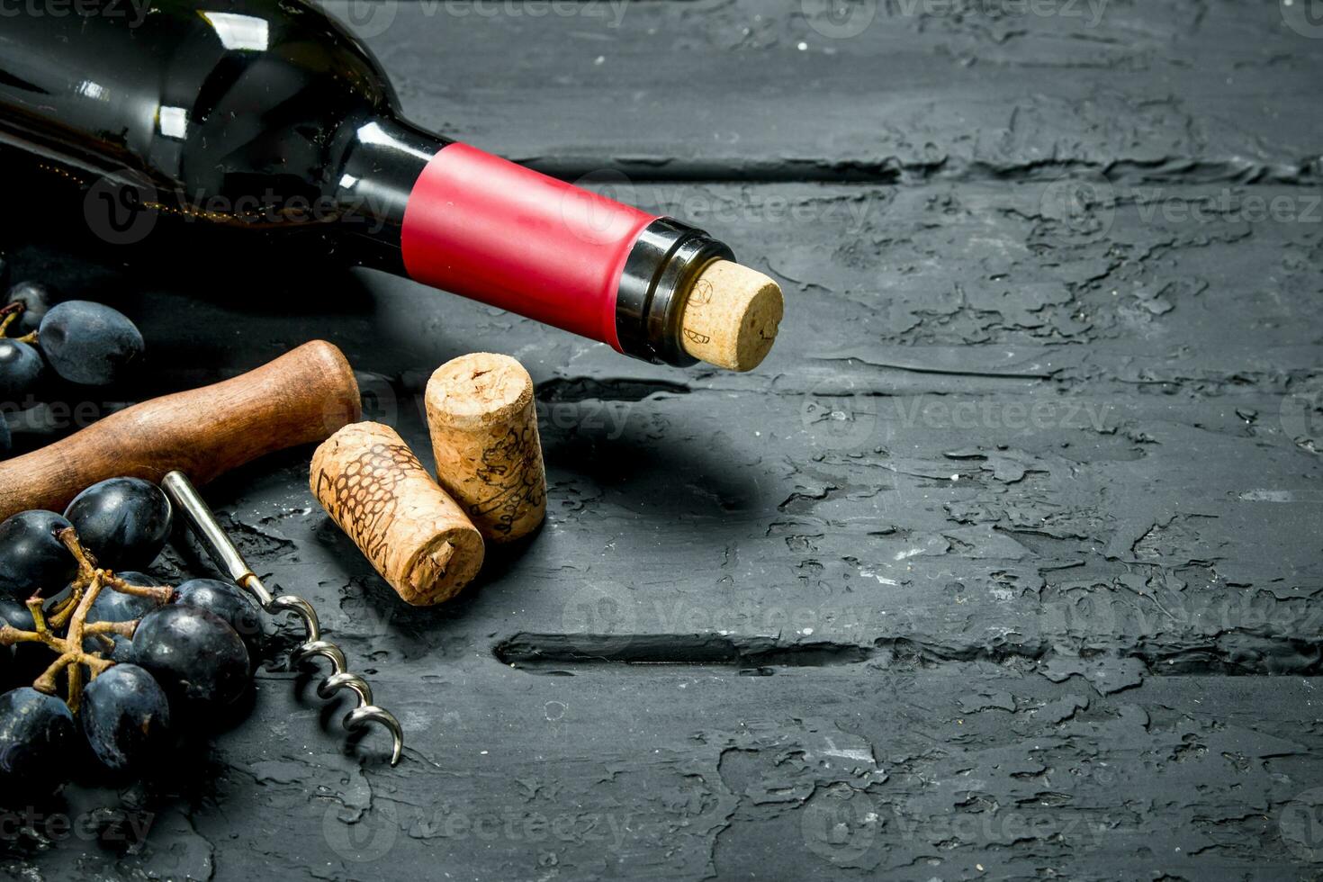 Wine background. Red wine with grapes and corkscrew. photo