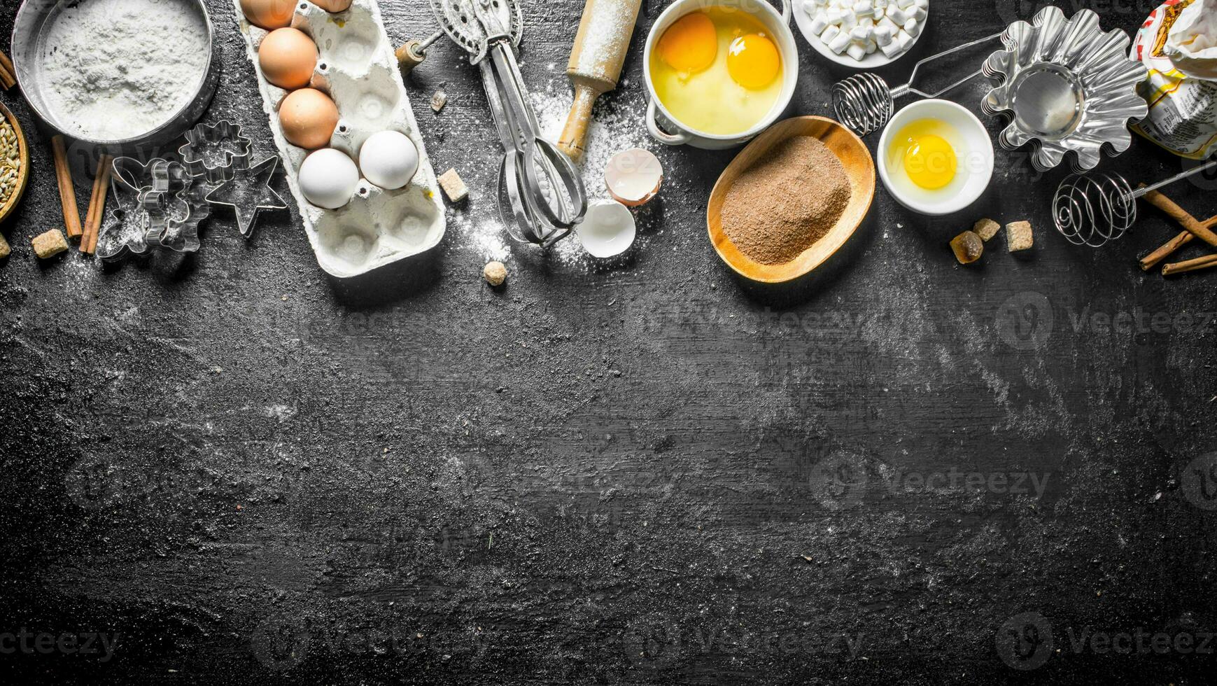 Baking background. Flour with cocoa, eggs and baking forms of the dough. photo
