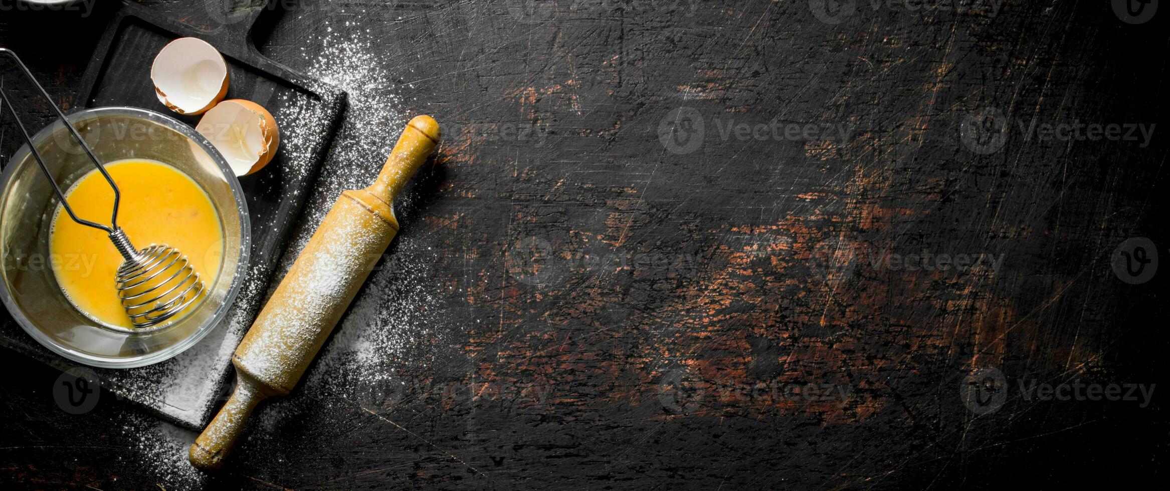 Egg with whisk and rolling pin. photo
