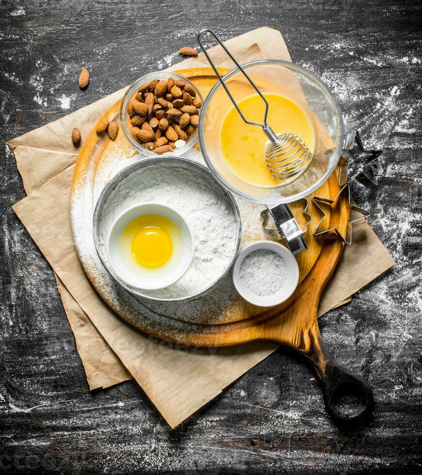 Baking background. Flour in a sieve with nuts and forms for dough. photo