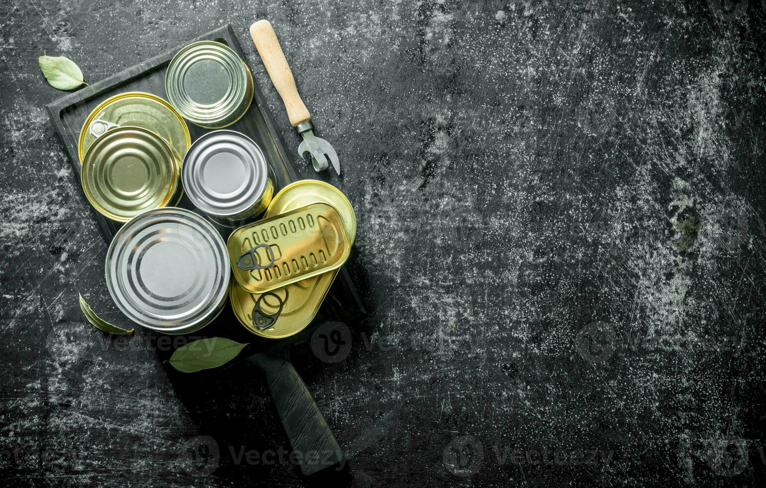 Tin cans of canned food on the cutting Board. photo
