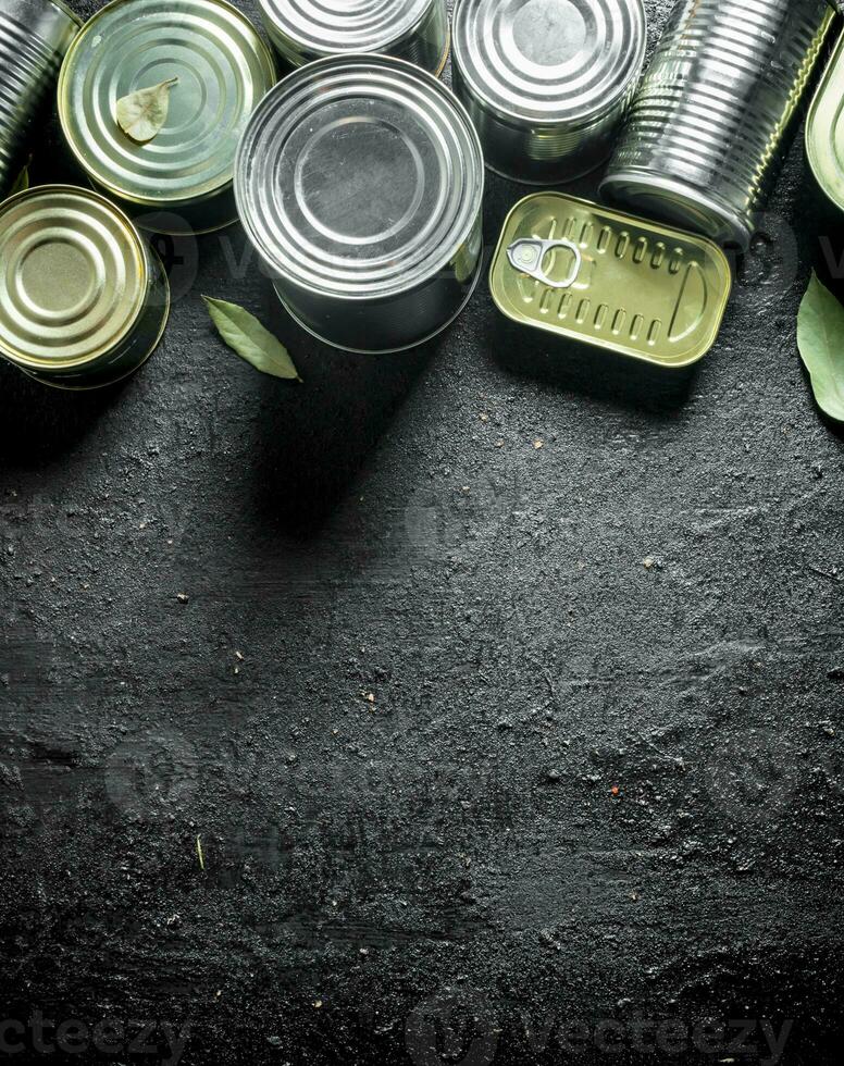 Set of different kinds of tin cans with canned food. photo