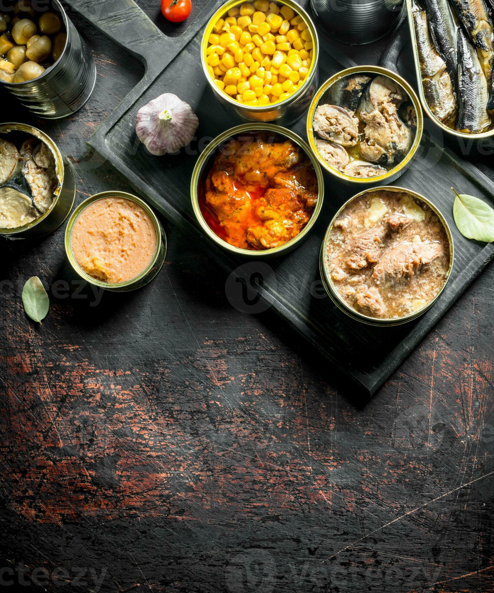 Assortment of various canned food in open cans. 32013068 Stock Photo at