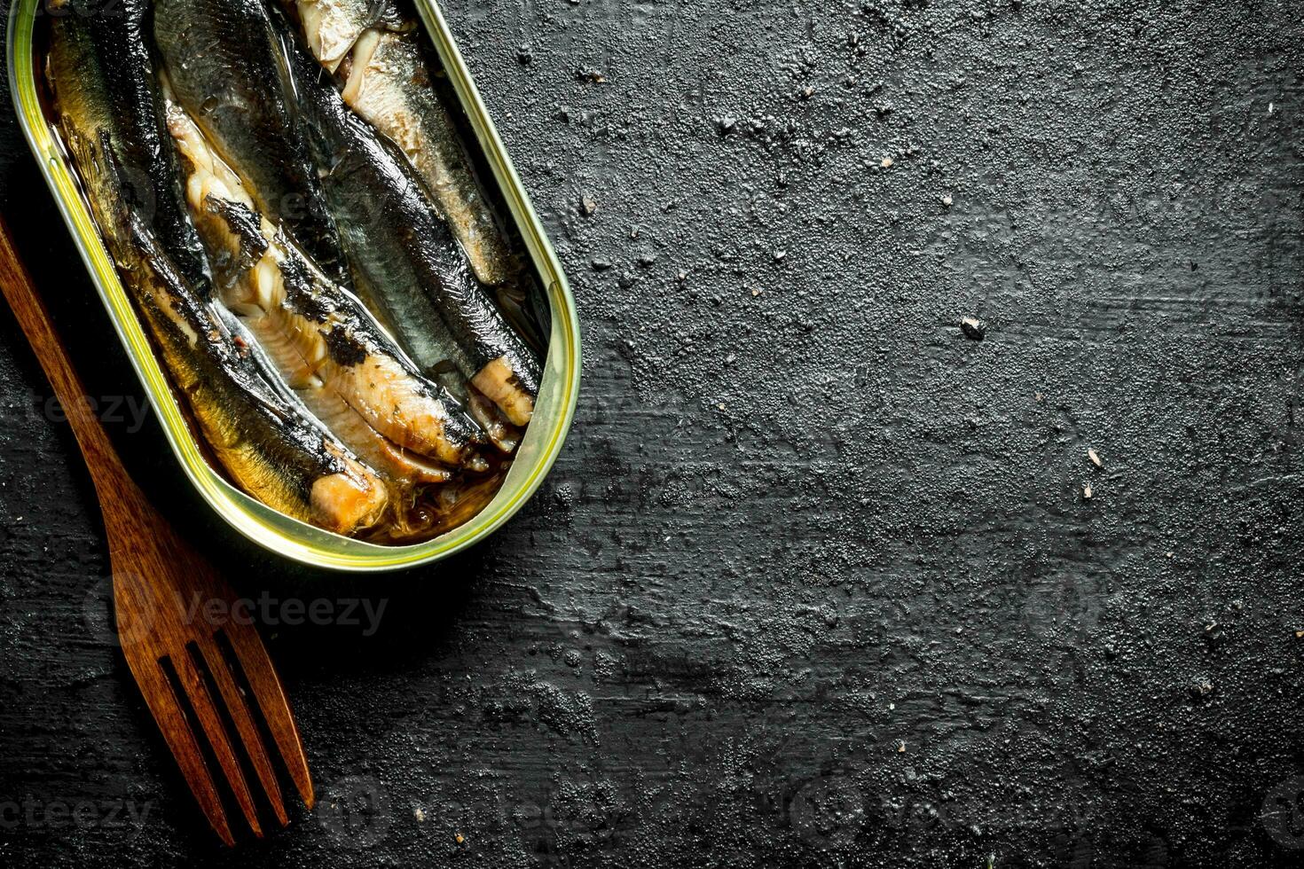 Open tin can with sprats. photo
