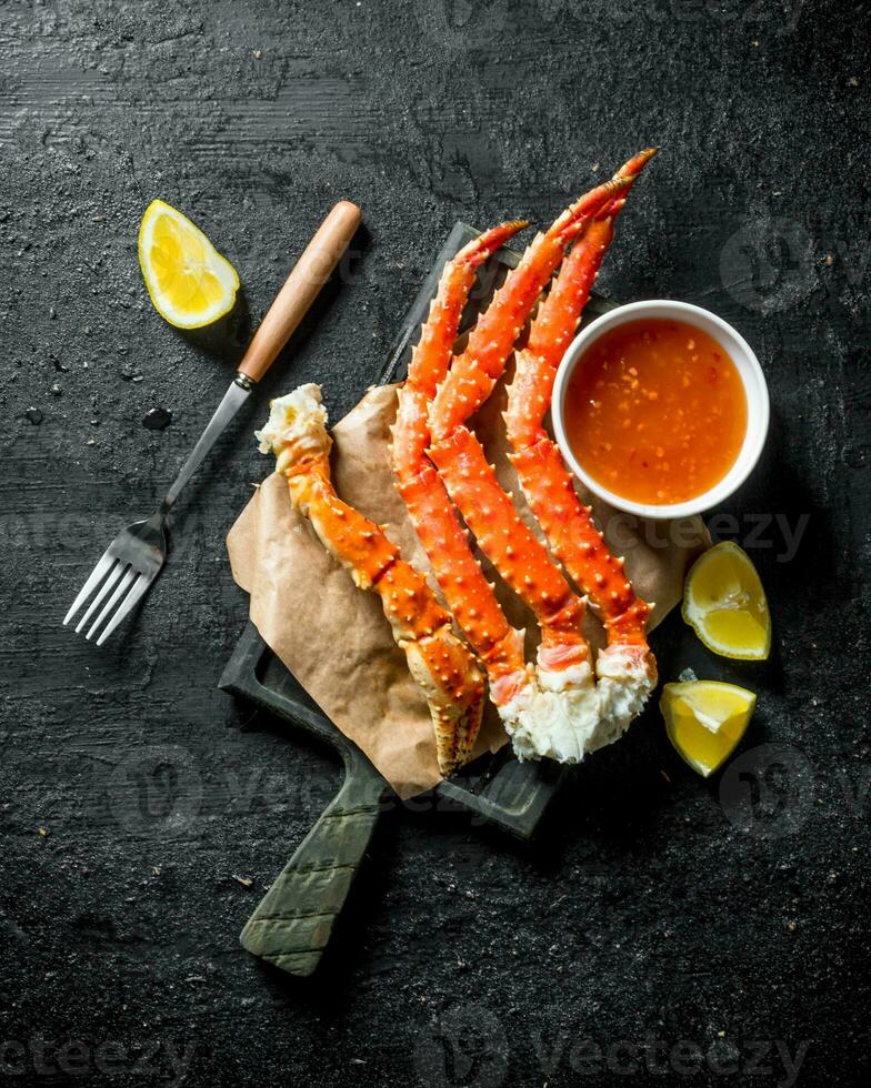 Sea crab with sauce and sliced lemon. photo
