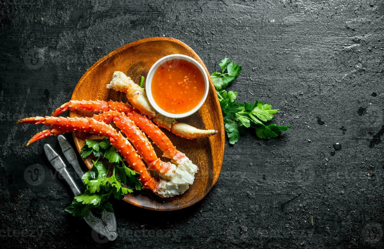 Fresh crab on a plate with parsley and sauce. photo