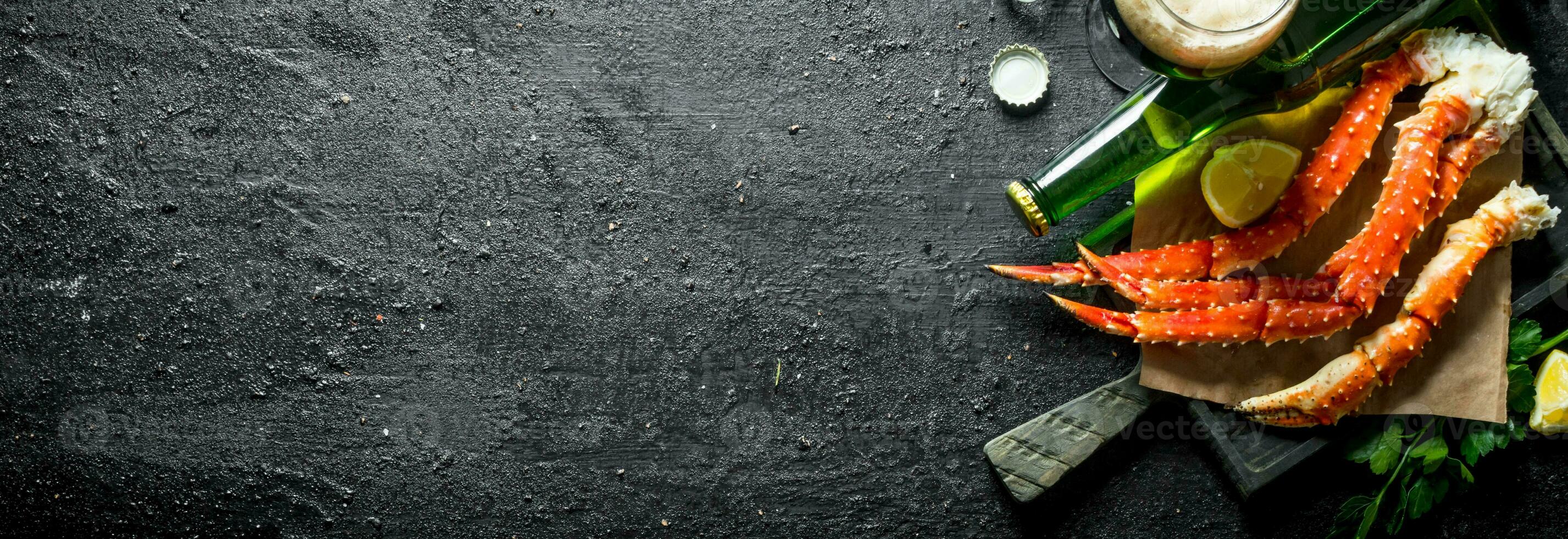 Crab on paper with beer and lemon. photo