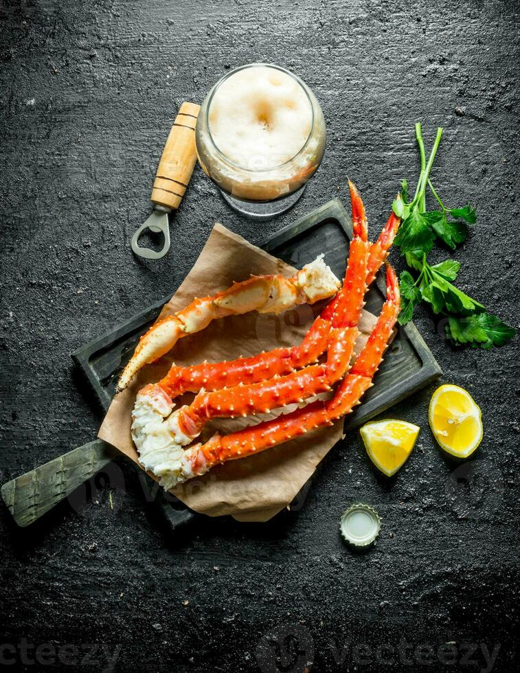 Crab with beer, parsley and lemon slices. photo