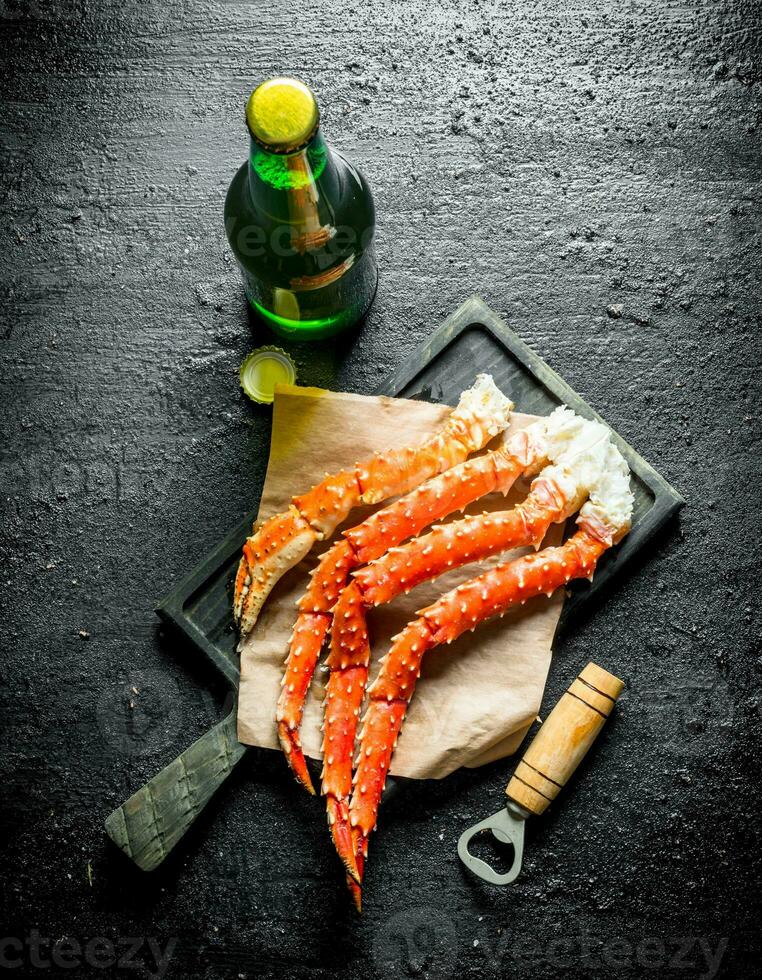Boiled crab on paper with a bottle of beer. photo