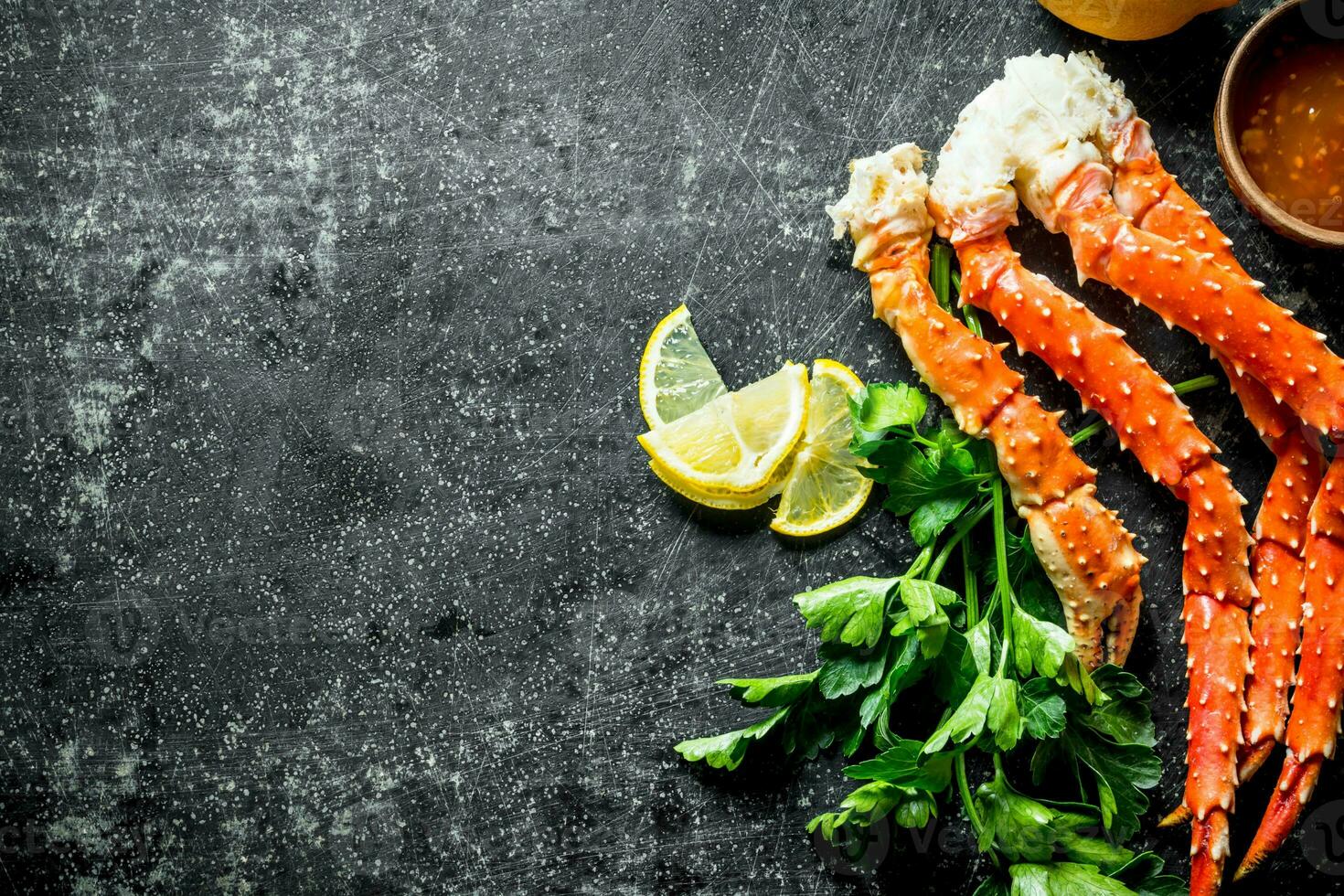 Crab with parsley, lemon slices and sauce. photo