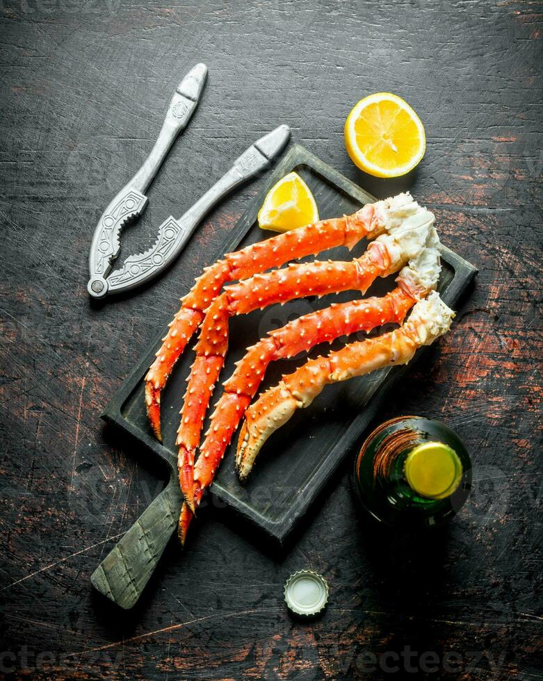 Crab on a cutting Board with a bottle of beer and slices of lemon. photo