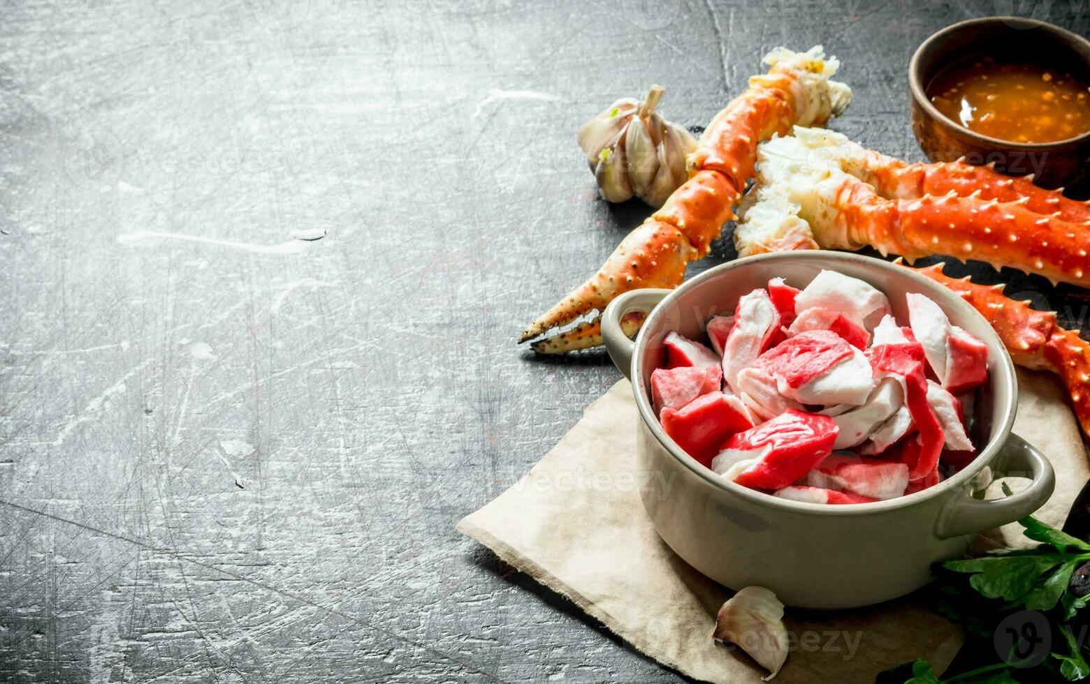Crab meat in bowl on paper with fresh crab and sauce. photo