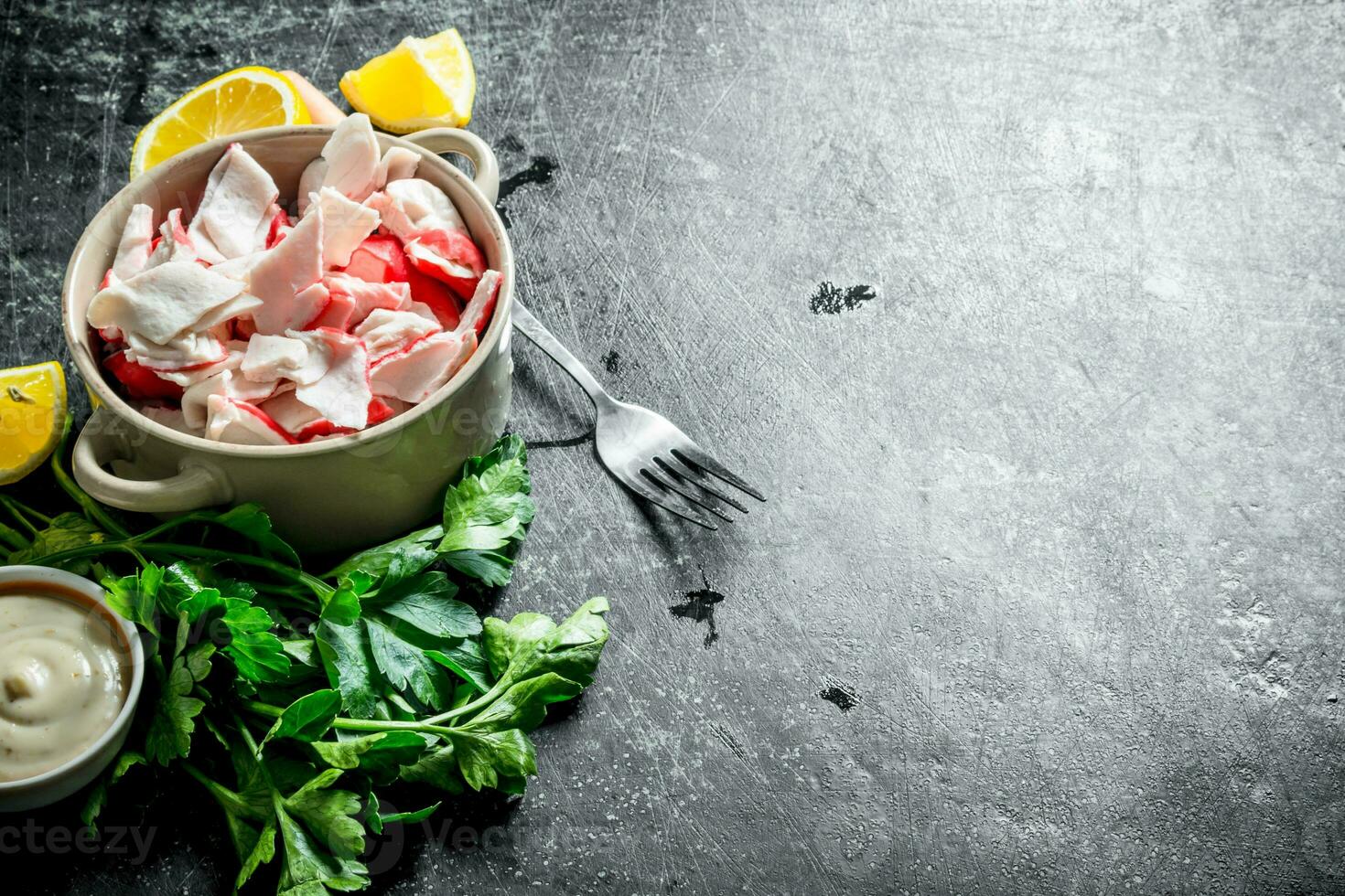 Crab meat with parsley, lemon slices and sauce. photo