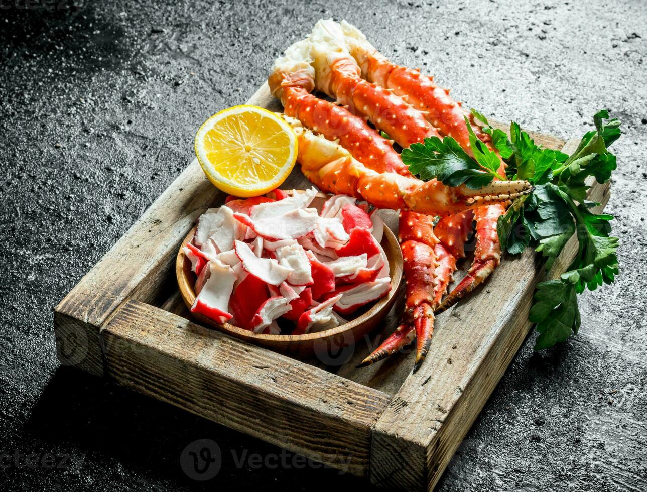 Crab meat and sea crab on tray with lemon and parsley. photo