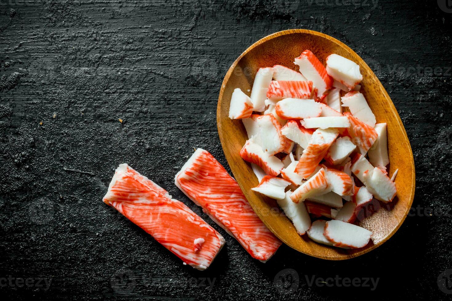 Sliced crab sticks on a plate. photo