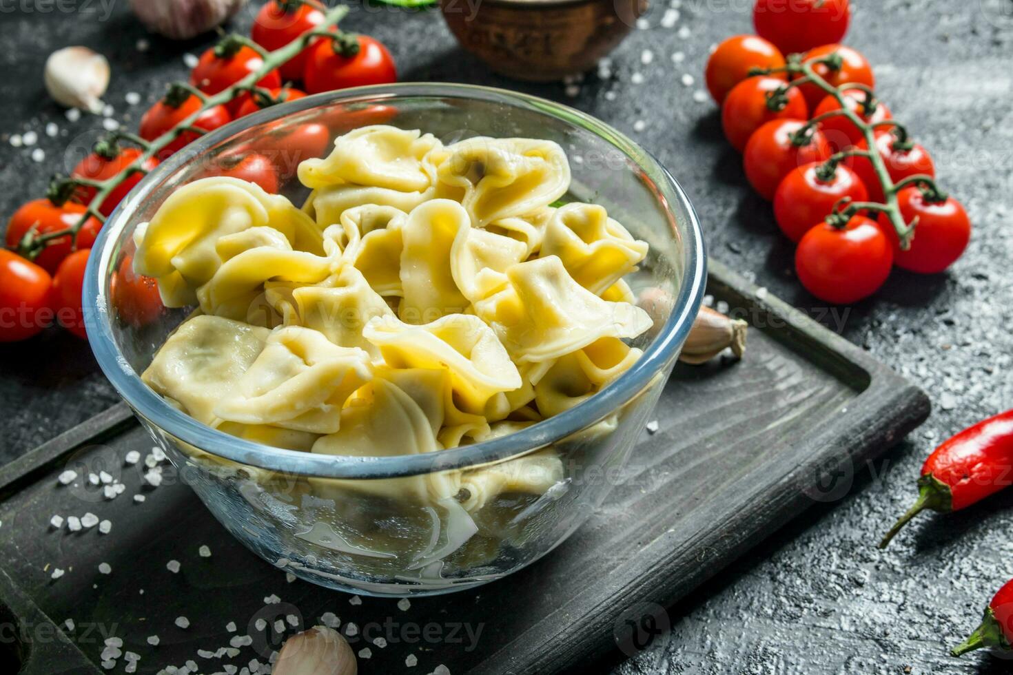 Meat dumplings in a glass bowl and cherry tomatoes. photo