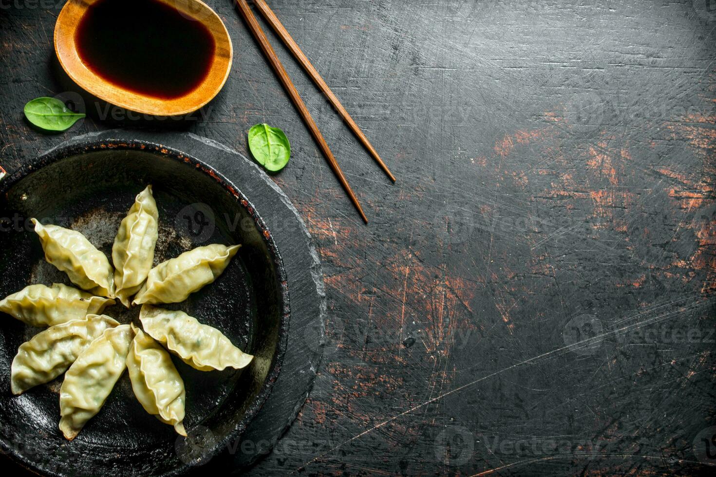 Delicious gedza dumplings in a pan with soy sauce. photo