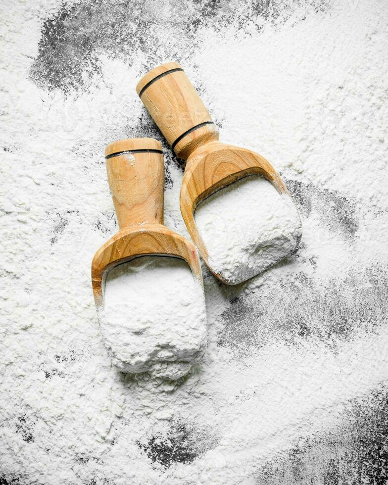 Flour in wooden scoops. photo