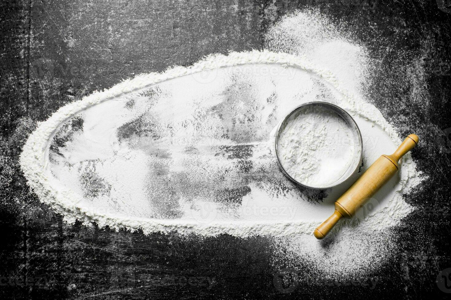 Flour with a sieve and a rolling pin. photo