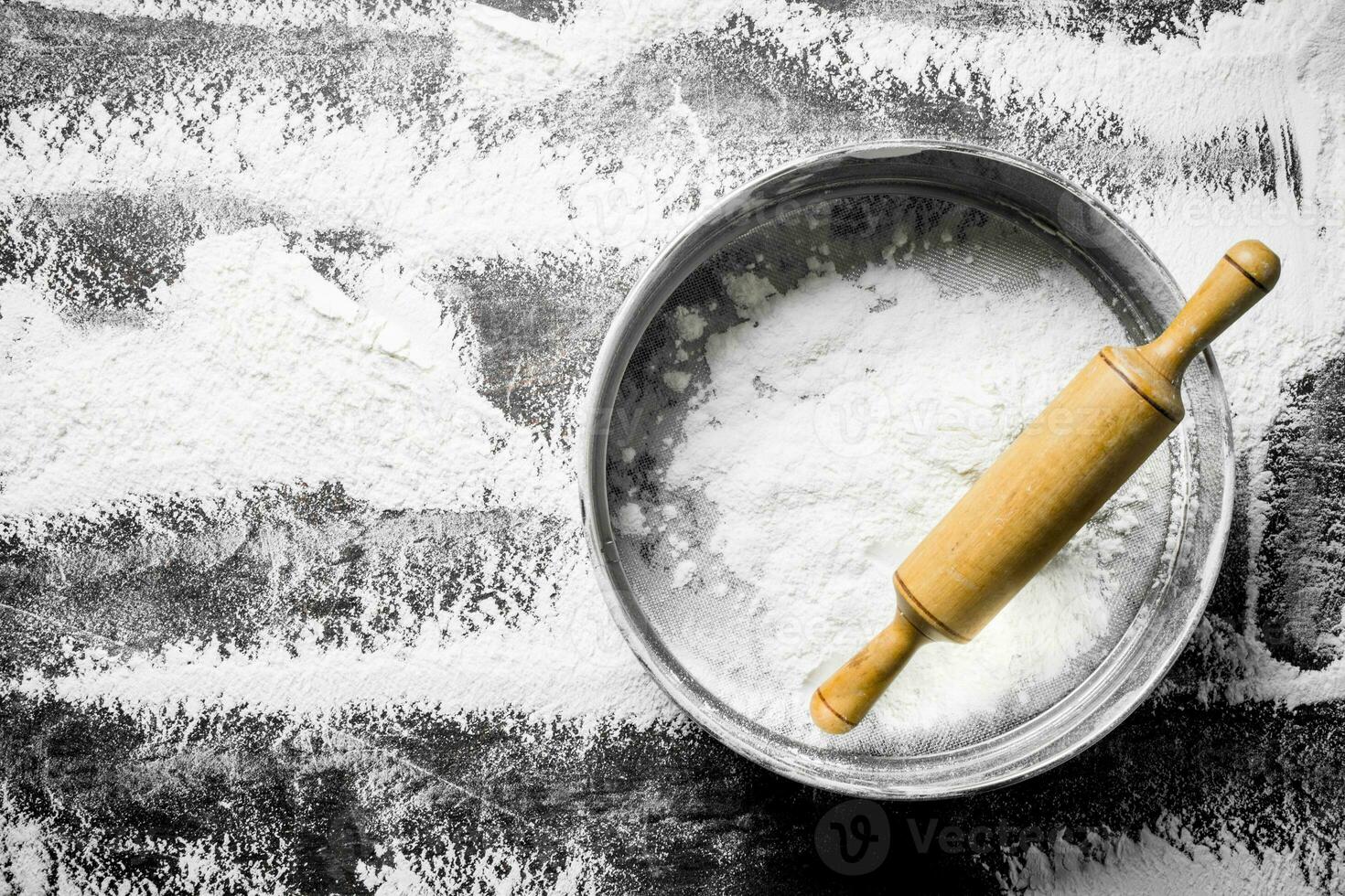 Flour with a sieve and a rolling pin. photo
