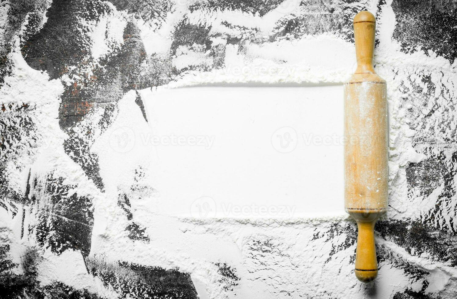 Texture of wheat flour with rolling pin. photo