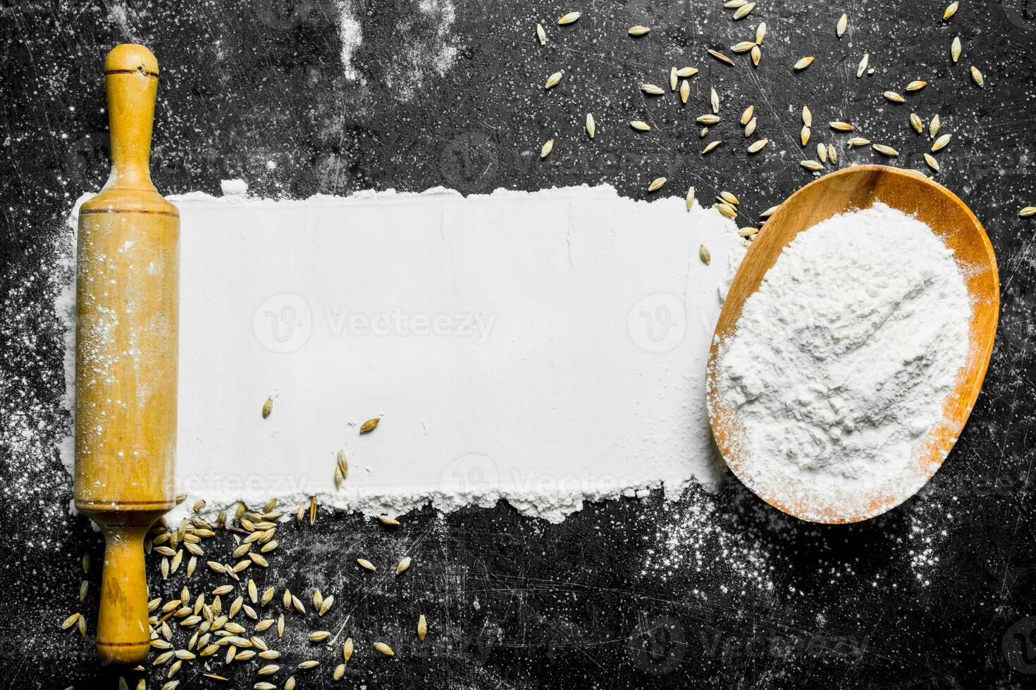 Flour with grain and rolling pin. photo