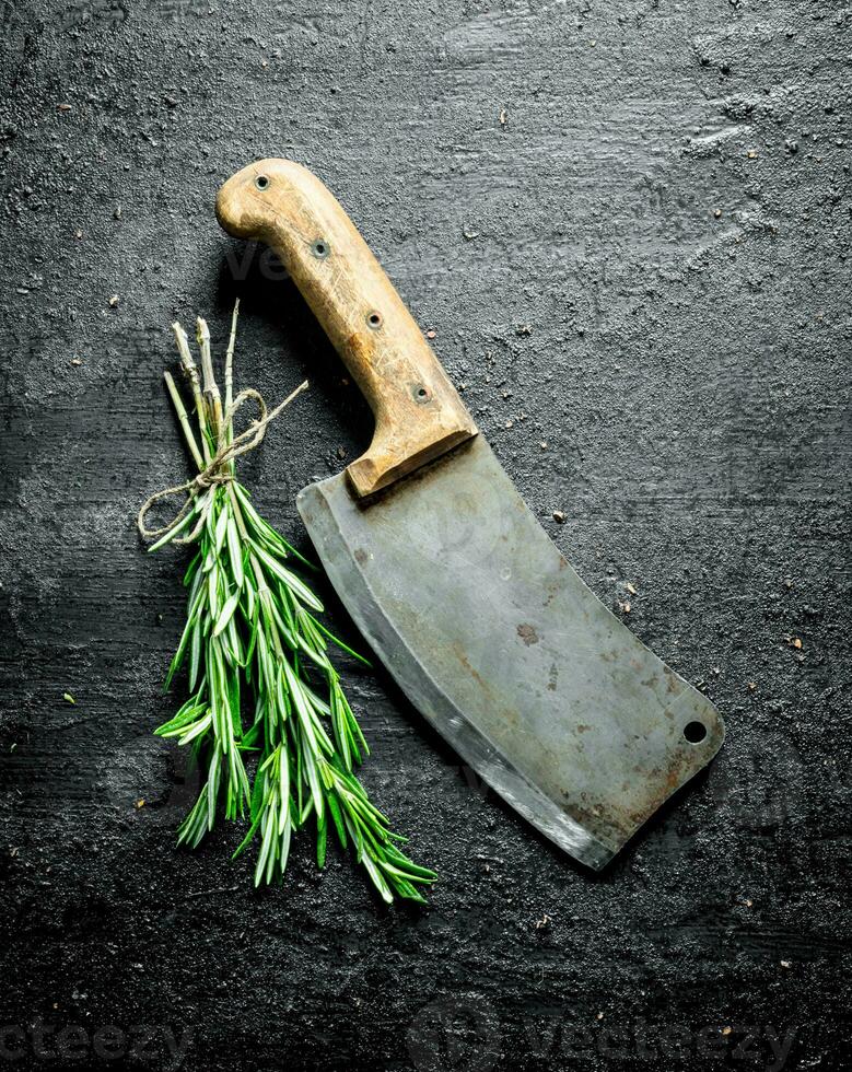 Bunch of fresh rosemary with a big knife. photo