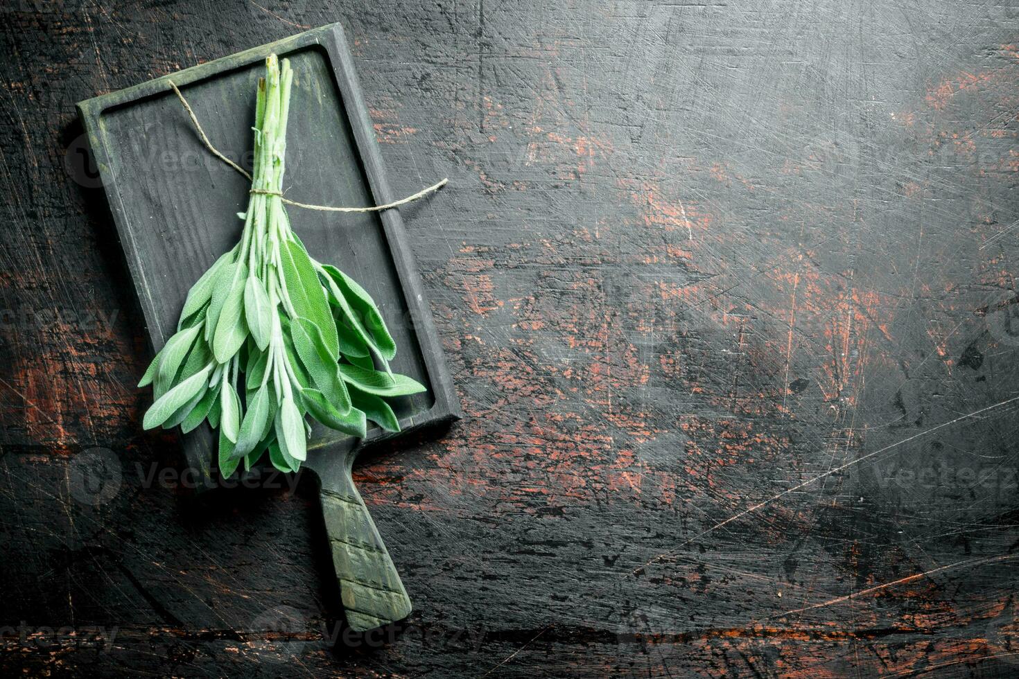 Bunch of fresh salvia on the cutting Board. photo