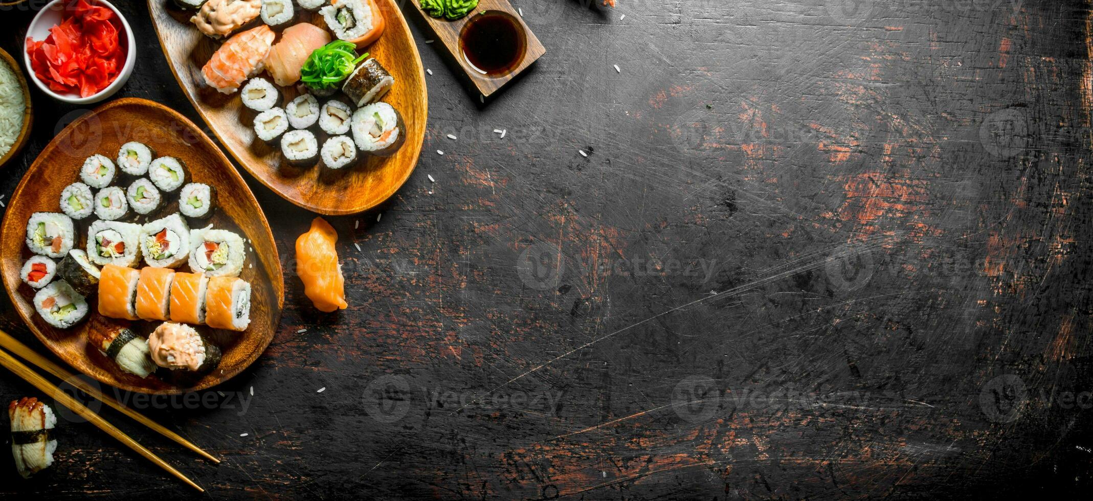 Assorted variety of sushi, rolls and Maki on the plates. photo