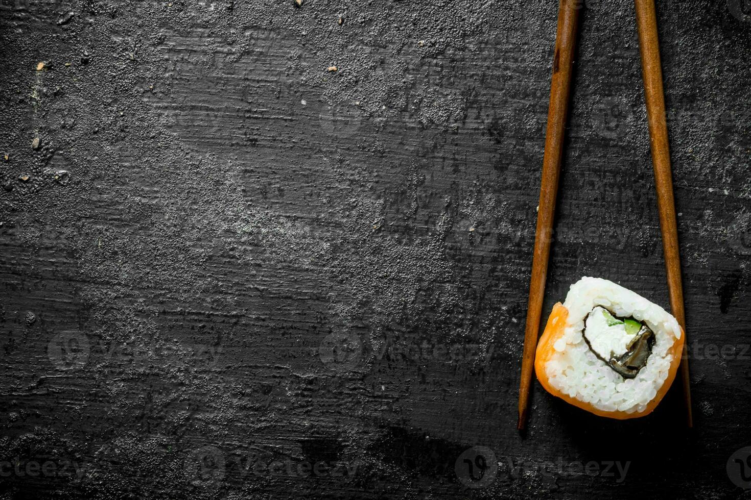 Piece of delicious Japanese sushi rolls with sticks. photo