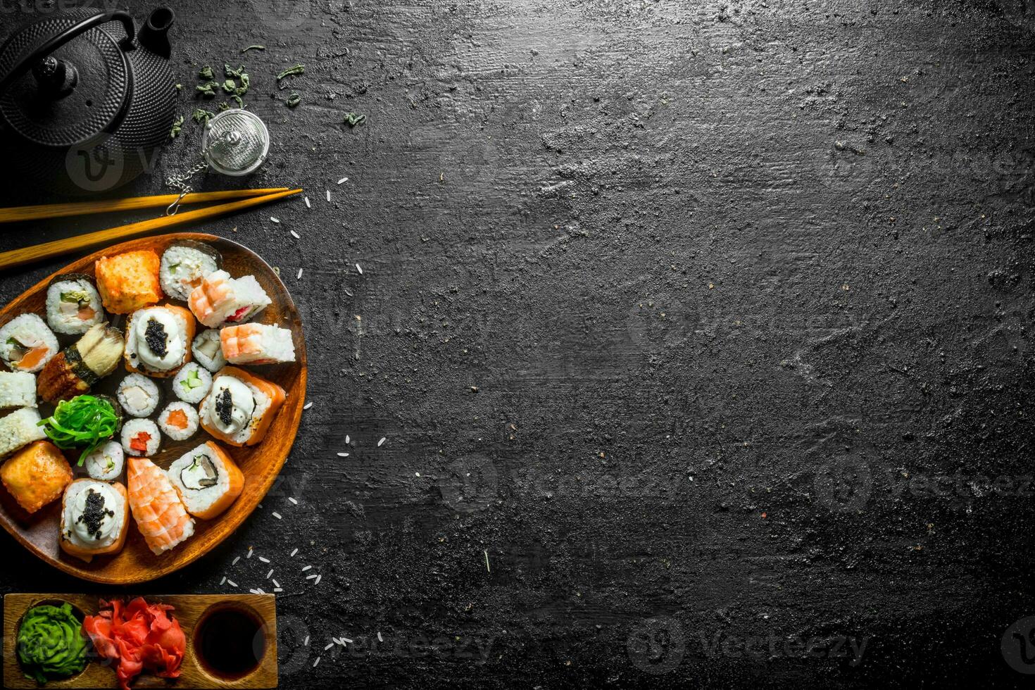 Fresh sushi and rolls with sauces and green tea. photo