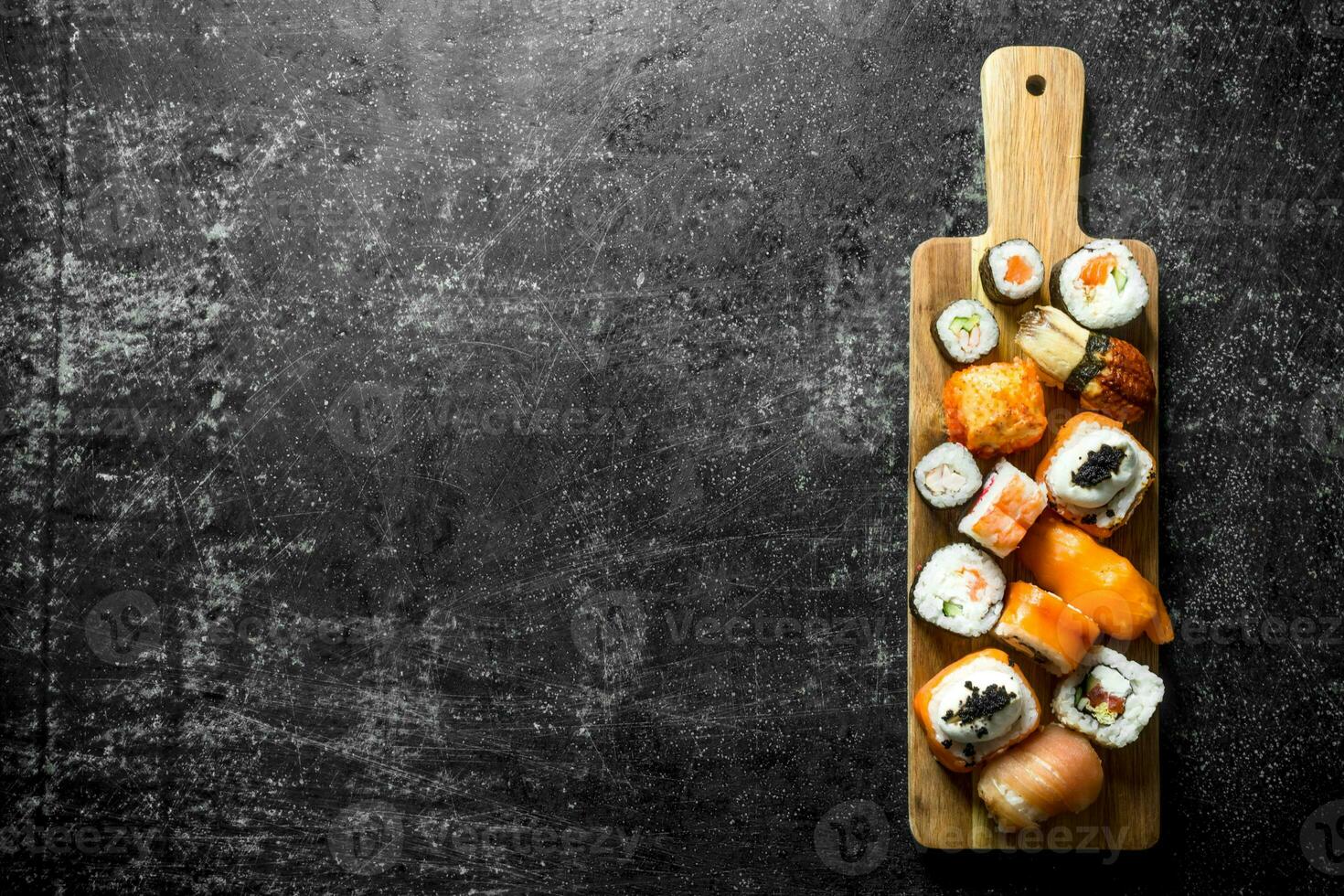 Freshly cooked sushi rolls on a cutting Board. photo