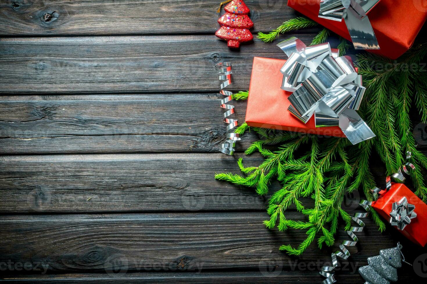 Red Christmas boxes with fir branches and streamers. photo