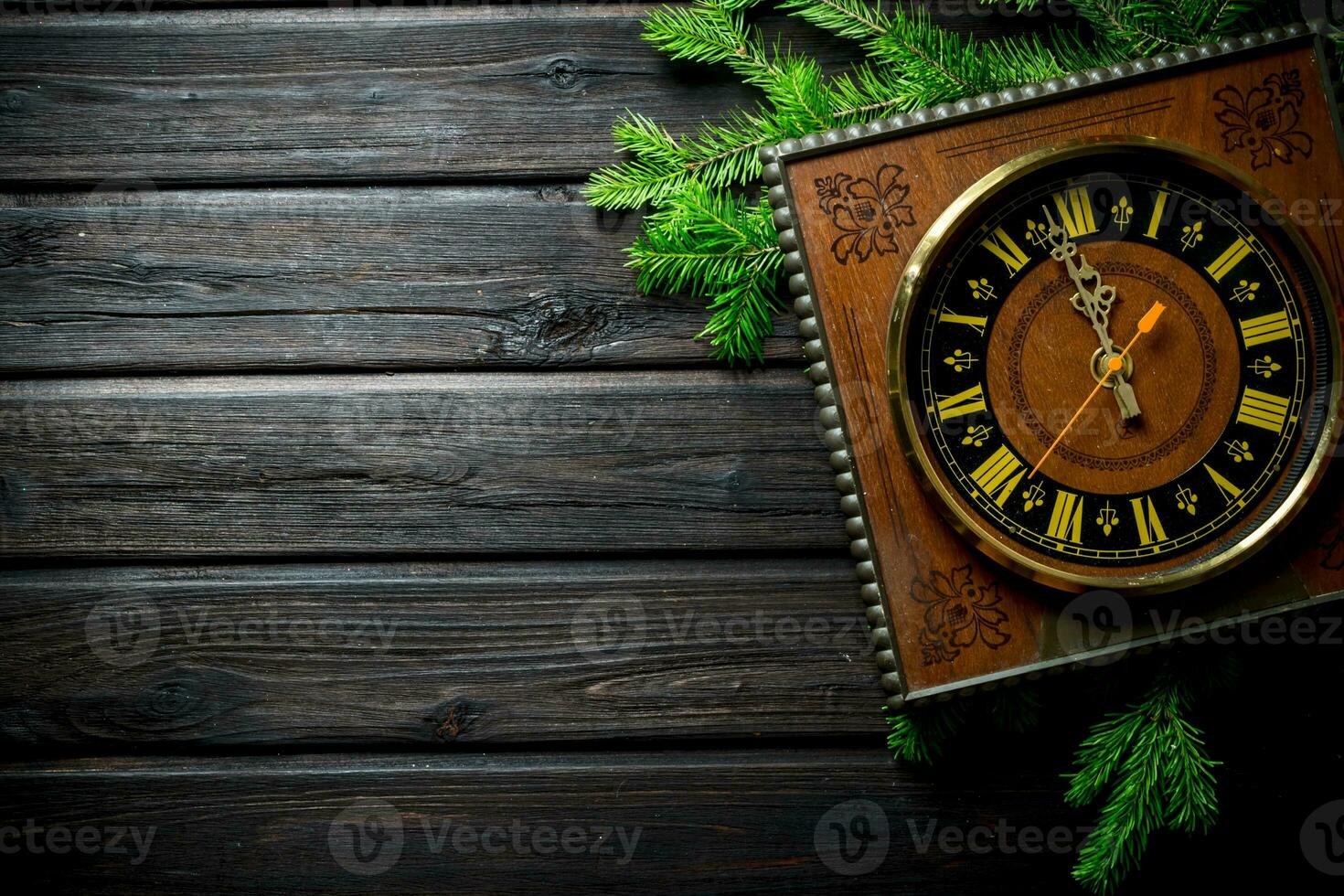 Retro Christmas clock with fir branches. photo