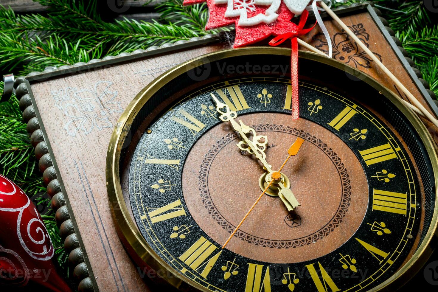 New year's clock on the spruce branches. photo