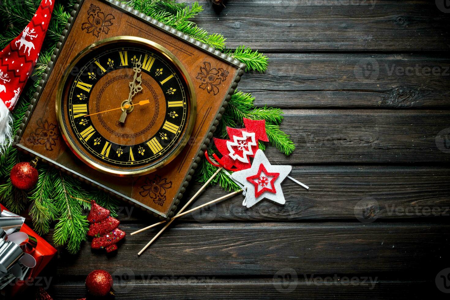 Old clock with Christmas decorations and fir branches. photo