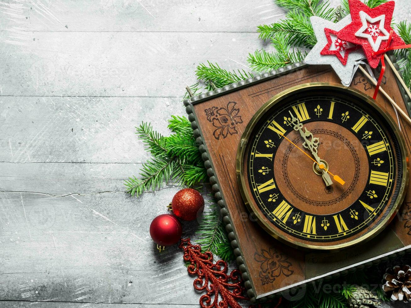 Clock with Christmas decorations and spruce branches. photo