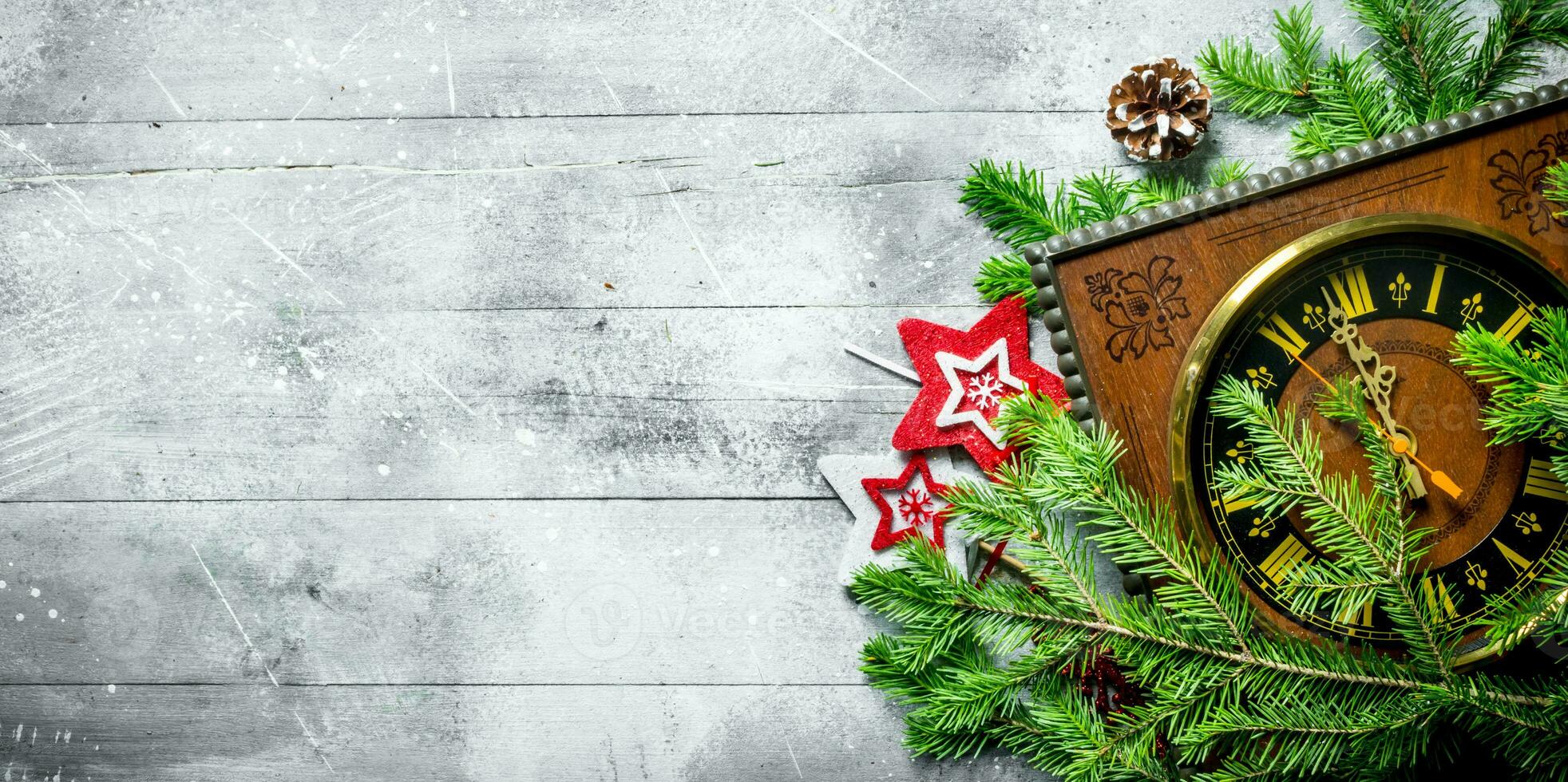 Clock with Christmas decorations and fir branches. photo