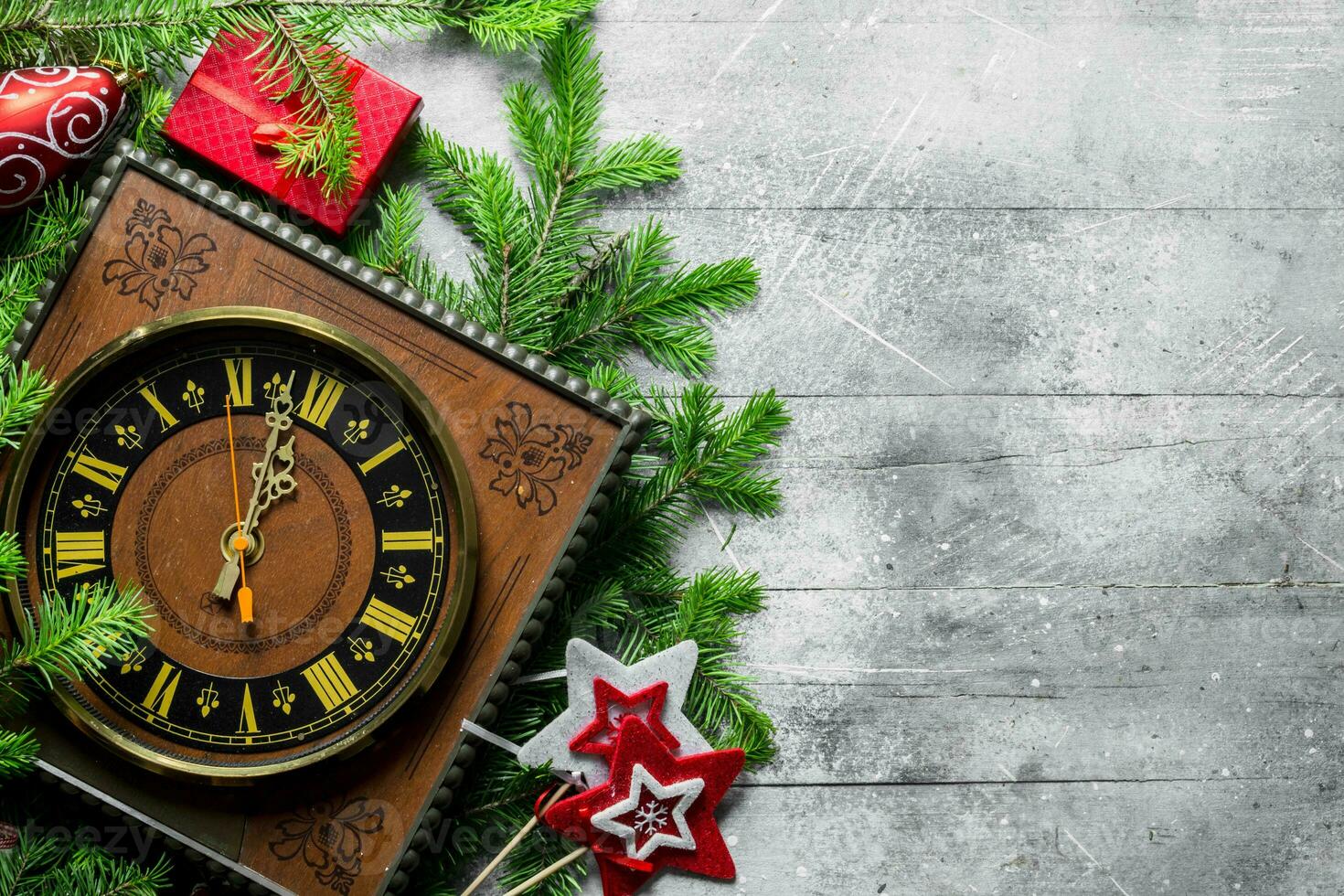 Clock with Christmas decorations and spruce branches. photo
