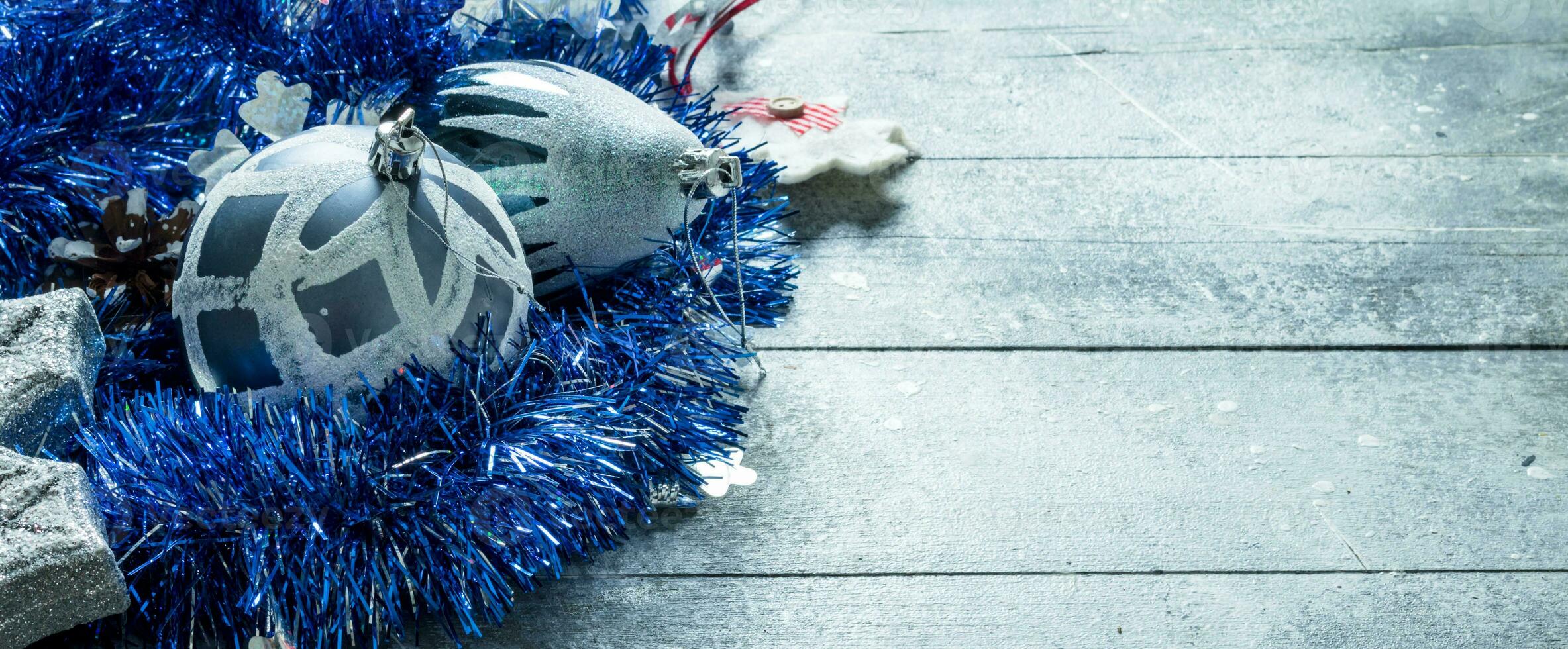 Christmas decorations with blue tinsel and a pine cone. photo